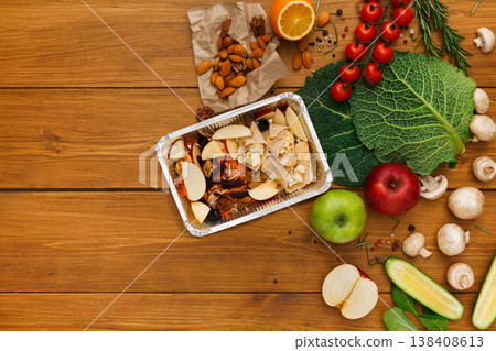 Healthy food delivery background. Lunch box with apples, nuts and salad on rustic wood table, copy space Healthy food delivery background. Lunch box with apples, nuts and salad on rustic wood table, copy space 138408613