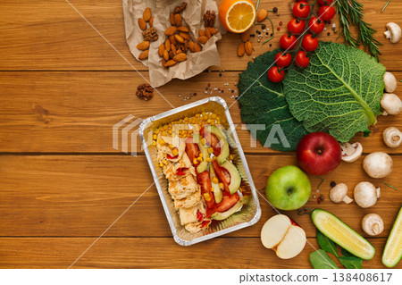 Healthy food delivery background. Lunch box with corn, chicken and salad on rustic wood table, copy space Healthy food delivery background. Lunch box with corn, chicken and salad on rustic wood table, copy space 138408617