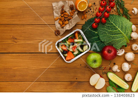 Healthy food delivery background. Lunch box with salad on rustic wood table, copy space 138408623