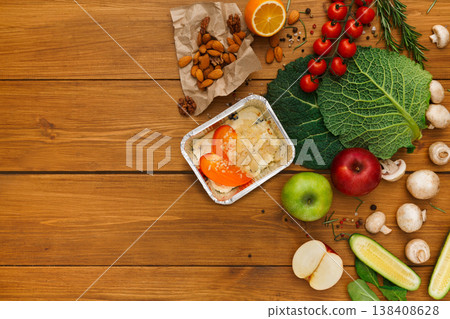 Healthy food delivery background. Lunch box with cottage cheese and persimmon on rustic wood table, copy space Healthy food delivery background. Lunch box with cottage cheese and persimmon on rustic wood table, copy space 138408628