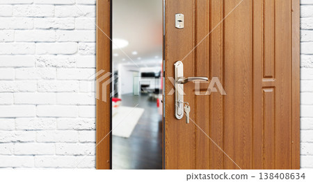Half opened door to a living room. Door handle, door lock. Lounge door half open. Opening door. Welcome, privacy concept. Entrance to the room. Door at white brick wall, modern interior design. Half opened door to a living room. Door handle, door lock. Lounge door half open. Opening door. Welcome, privacy concept. Entrance to the room. Door at white brick wall, modern interior design. 138408634