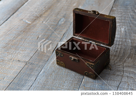 Wooden chest or trunk vintage style. Open Wooden chest box at serenity colored wooden plank table background. With copyspace. 138408645