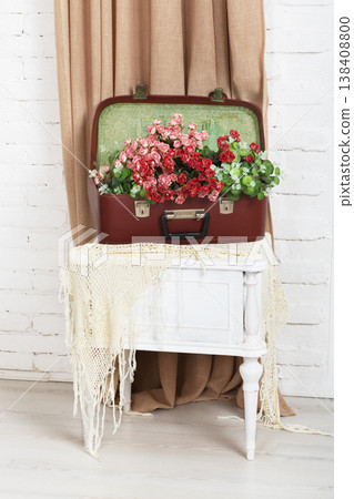 Shabby chic wedding. Wedding floral decor composition, flowers in vintage brown suitcase at bedside. Old suitcase with bouquet roses. Vintage, rustic, country decor. Floristic decoration. Flowerbed. Shabby chic wedding. Wedding floral decor composition, flowers in vintage brown suitcase at bedside. Old suitcase with bouquet roses. Vintage, rustic, country decor. Floristic decoration. Flowerbed. 138408800