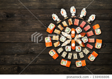 Japanese food restaurant, sushi maki gunkan roll plate or platter set. Sushi at rustic wood background. Top view, flat lay. Big party sushi set. Top view with copyspace Japanese food restaurant, sushi maki gunkan roll plate or platter set. Sushi at rustic wood background. Top view, flat lay. Big party sushi set. Top view with copyspace 138408806