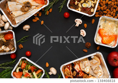Healthy restaurant food delivery background with copy space. Mockup for menu, foil containers with meals on black Healthy restaurant food delivery background with copy space. Mockup for menu, foil containers with meals on black 138408818