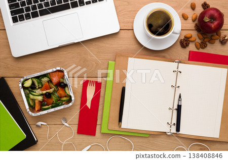 Healthy Lunch at workplace. Foil box with diet meal, flat lay of wooden desktop with foiled container, copy space Healthy Lunch at workplace. Foil box with diet meal, flat lay of wooden desktop with foiled container, copy space 138408846