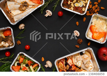 Healthy restaurant food delivery background with copy space. Mockup for menu, foil containers with meals on black Healthy restaurant food delivery background with copy space. Mockup for menu, foil containers with meals on black 138408850