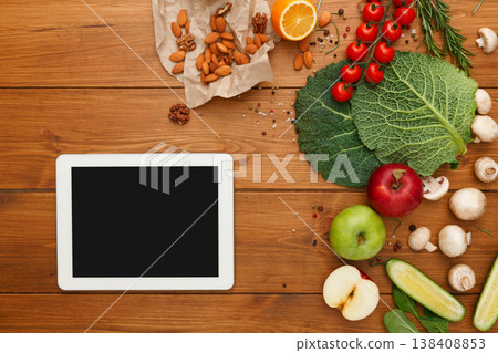 Healthy food, grocery online shopping, copy space on tablet screen. Fresh organic vegetables and fruits on wood table, top view, flat lay 138408853