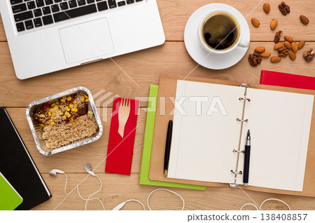 Healthy food delivery. Lunch box with diet meal on workplace, flat lay of wooden desktop with foiled container, copy space 138408857