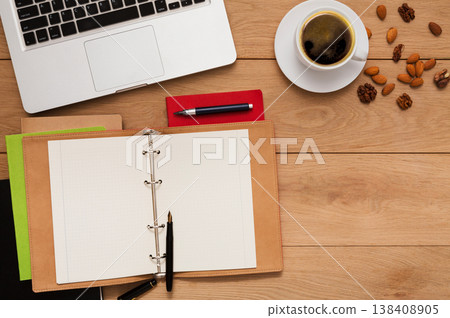 Healthy lunch at workplace. Coffee with nuts on wooden desktop, copy space Healthy lunch at workplace. Coffee with nuts on wooden desktop, copy space 138408905
