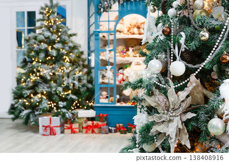 Christmas magical atmosphere background. Modern interior design for winter holidays. Pine trees decorated with shining lights, showcase with toys and present boxes Christmas magical atmosphere background. Modern interior design for winter holidays. Pine trees decorated with shining lights, showcase with toys and present boxes 138408916