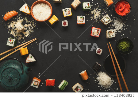Sushi and rolls background, frame on black, top view. Colorful japanese restaurant food set, copy space Sushi and rolls background, frame on black, top view. Colorful japanese restaurant food set, copy space 138408925
