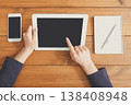 Female using digital tablet. Freelancer working with portable computer, copy space on display, top view, close up 138408948