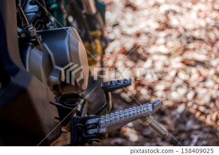 Motorcycle engine and footpegs, mechanical details, high color saturation. Motorcycle engine and footpegs, mechanical details, high color saturation. 138409025