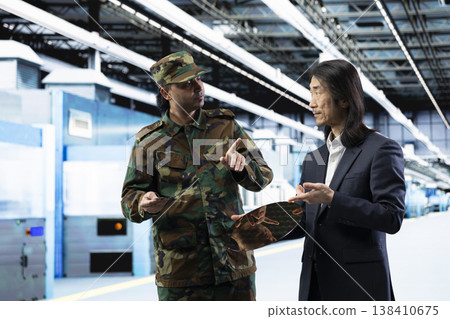 Upgrading silicon wafer supply chain, national security and army man talking with senior manager. Reviewing military strategy, microelectronics production and soldier with Asian factory director Upgrading silicon wafer supply chain, national security and army man talking with senior manager. Reviewing military strategy, microelectronics production and soldier with Asian factory director 138410675