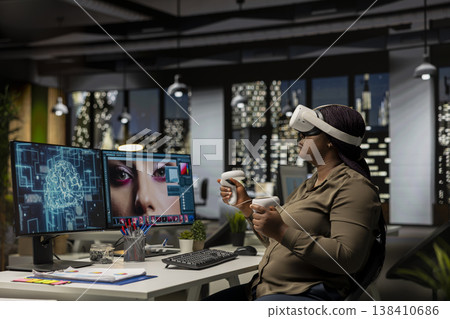 African american woman uses VR headset and AI to edit photos, retouching content and generating professional materials. Graphic editor turning text to image with virtual reality. African american woman uses VR headset and AI to edit photos, retouching content and generating professional materials. Graphic editor turning text to image with virtual reality. 138410686