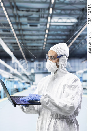 Overseeing PCB infrastructure, laptop and man working in production factory. Tracking semiconductor fabrication lots, notebook and engineer in microchips manufacturing plant cleanroom Overseeing PCB infrastructure, laptop and man working in production factory. Tracking semiconductor fabrication lots, notebook and engineer in microchips manufacturing plant cleanroom 138410718