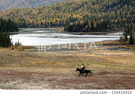 Silhouette of a horse galloping across the Kanas plains Silhouette of a horse galloping across the Kanas plains 138410916