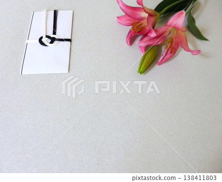 A condolence envelope and a pink lily A condolence envelope and a pink lily 138411803