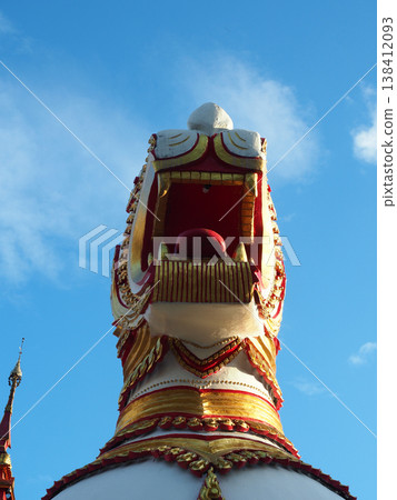 Mythical lion statue temple sculpture asian architecture gold detail red ornament blue sky background religious art cultural 138412093