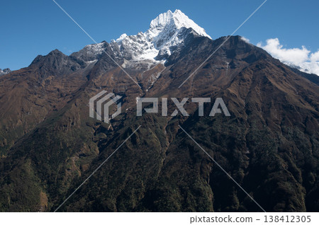 Scenery view of Mt.Thamserku (6723m) seen from the area nearby Namche Bazaar, Nepal. Thamserku lies in Mahalangur sub-range  connecting east leading ridge to Mt.Kangtega. 138412305