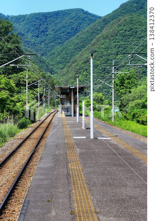 Surrounded by lush green mountains in early summer in Oku-Kinugawa... Nakami-Onsen Station 138412370