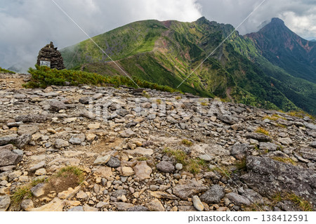 View of Yokodake and Akadake, shrouded in clouds, from Ioudake in the Yatsugatake mountain range. 138412591