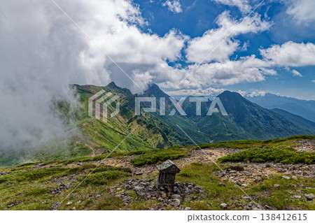 A view of the cloud-filled Yokodake, Akadake, and Amidadake peaks from Ioudake in the Yatsugatake mountain range. A view of the cloud-filled Yokodake, Akadake, and Amidadake peaks from Ioudake in the Yatsugatake mountain range. 138412615