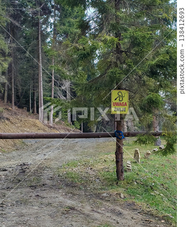 Warning sign about the presence of snakes in this forest. High quality photo Warning sign about the presence of snakes in this forest. High quality photo 138412693