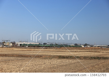 一列向東行駛的JR宇都宮線列車正穿過鄉村地區。 一列向東行駛的JR宇都宮線列車正穿過鄉村地區。 138412703