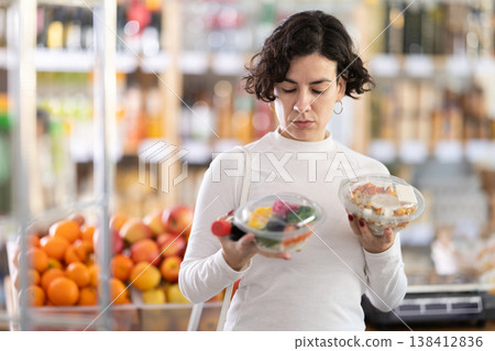 In store, woman near counter are looking at poke salad 138412836