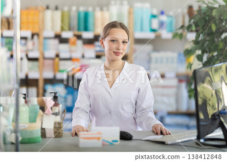 Female pharmacist standing near counter in pharmacy Female pharmacist standing near counter in pharmacy 138412848