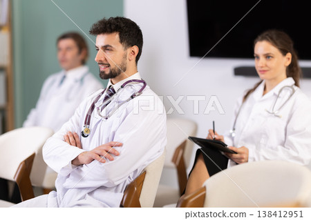 Medical students or doctors attending training session in modern lecture room Medical students or doctors attending training session in modern lecture room 138412951