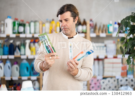 man buys toothbrushes man buys toothbrushes 138412963
