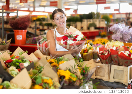 Young woman choosing bouquet of flowers Young woman choosing bouquet of flowers 138413053