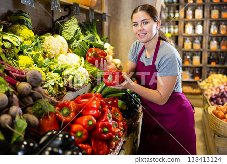 Young woman selling bell peppers in shop Young woman selling bell peppers in shop 138413124