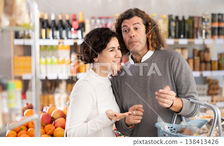 Husband and wife buying food in the supermarket 138413426
