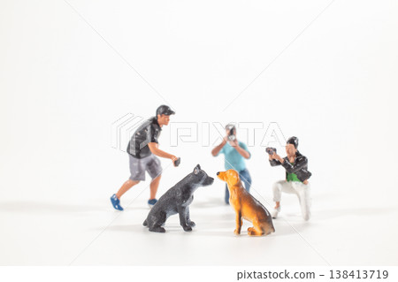Miniature photographers capturing two dogs posing together Miniature photographers capturing two dogs posing together 138413719