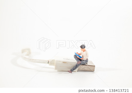 A Miniature worker striking worn charging cable 138413721