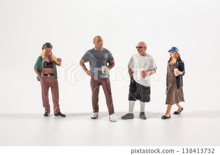 Miniature group figures standing casually with drinks Miniature group figures standing casually with drinks 138413732