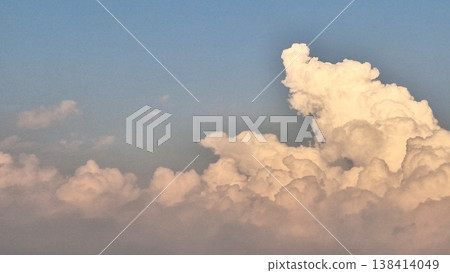Dramatic Fluffy White Clouds with Golden Sunlight Glow in the Evening Blue Sky Dramatic Fluffy White Clouds with Golden Sunlight Glow in the Evening Blue Sky 138414049