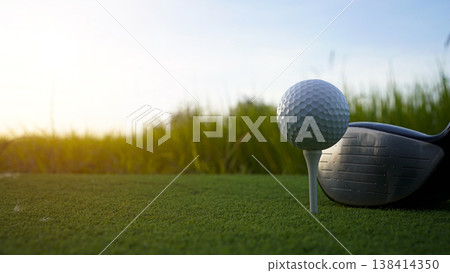 Golf clubs and balls on a green lawn in a beautiful golf course with morning sunshine. Golf clubs and balls on a green lawn in a beautiful golf course with morning sunshine. 138414350