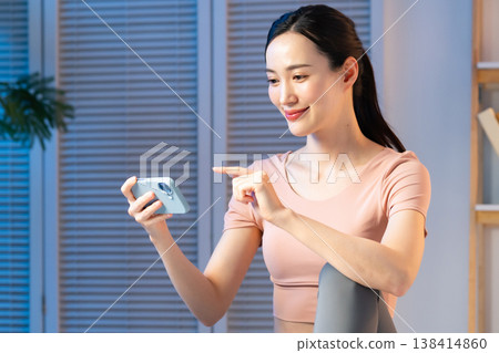 A young lady with a smartphone 138414860