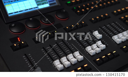 Lighting mixer buttons and faders close up with panning camera movement. 4k Lighting mixer buttons and faders close up with panning camera movement. 4k 138415170