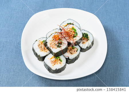 Korean-style seaweed rolls (kimbap) are served on a white plate with plenty of fillings. Korean-style seaweed rolls (kimbap) are served on a white plate with plenty of fillings. 138415841
