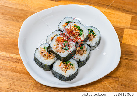 Korean-style seaweed rolls (kimbap) are served on a white plate with plenty of fillings. Korean-style seaweed rolls (kimbap) are served on a white plate with plenty of fillings. 138415866