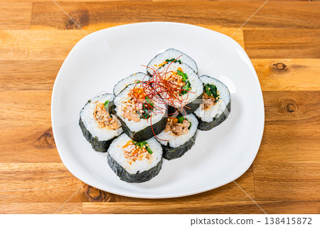 Korean-style seaweed rolls (kimbap) are served on a white plate with plenty of fillings. Korean-style seaweed rolls (kimbap) are served on a white plate with plenty of fillings. 138415872