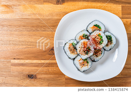 Korean-style seaweed rolls (kimbap) are served on a white plate with plenty of fillings. Korean-style seaweed rolls (kimbap) are served on a white plate with plenty of fillings. 138415874