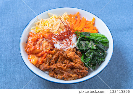 Bibimbap with soft-boiled egg, vegetables, and pork: A colorful Korean rice bowl dish. Bibimbap with soft-boiled egg, vegetables, and pork: A colorful Korean rice bowl dish. 138415896