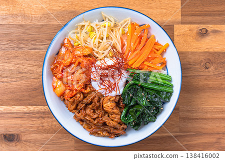 Bibimbap with soft-boiled egg, vegetables, and pork: A colorful Korean rice bowl dish. Bibimbap with soft-boiled egg, vegetables, and pork: A colorful Korean rice bowl dish. 138416002